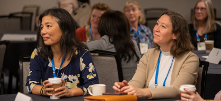 Meeting attendees listening at a session